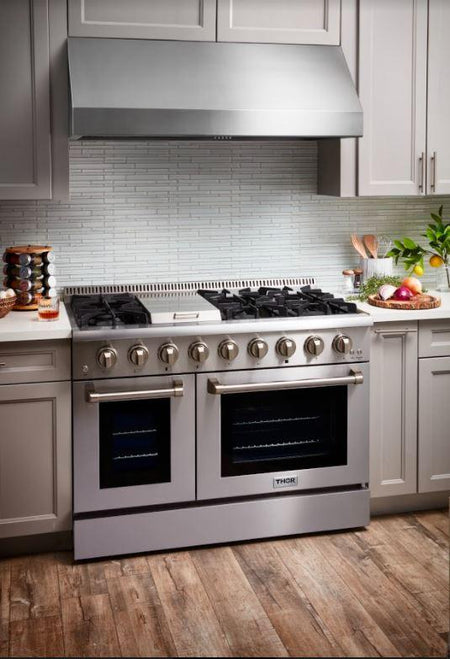 Front far view of the Thor Kitchen Range 48-inch, 6.7 cu. ft. Professional Natural Gas Range in Stainless Steel, HRG4808U, with the oven door closed, set in a modern kitchen